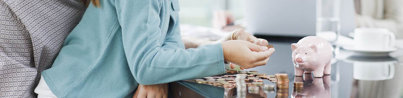 Child counting savings from piggy bank