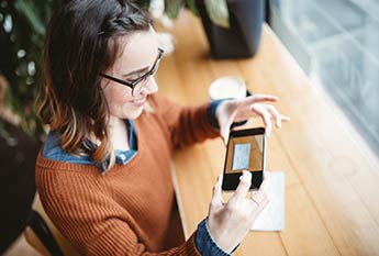 Woman smiling while using Mobile deposit